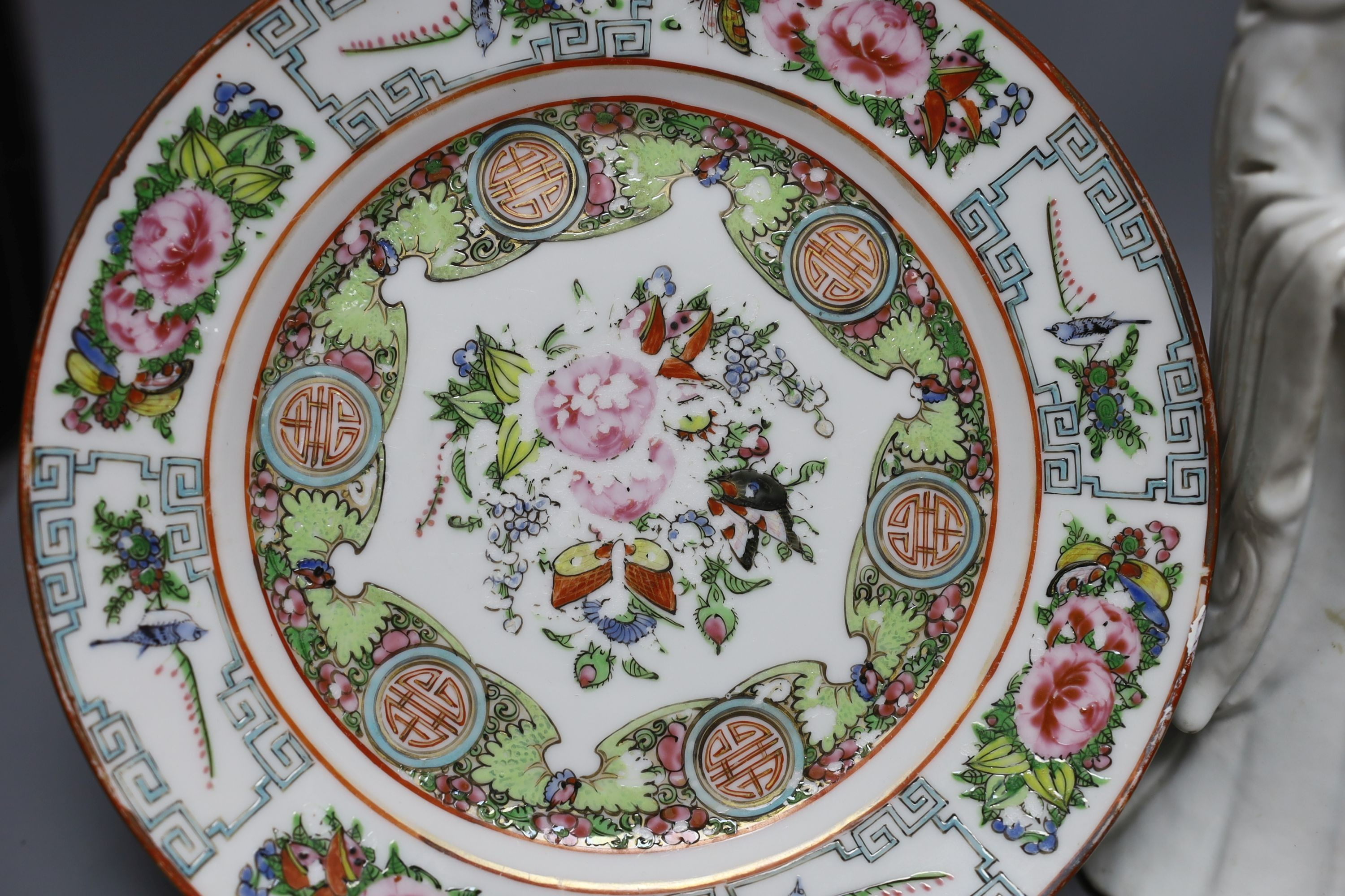 A Chinese blanc de chine figure of Guanyin, probably 18th century and two famille rose plates. Tallest 26cm